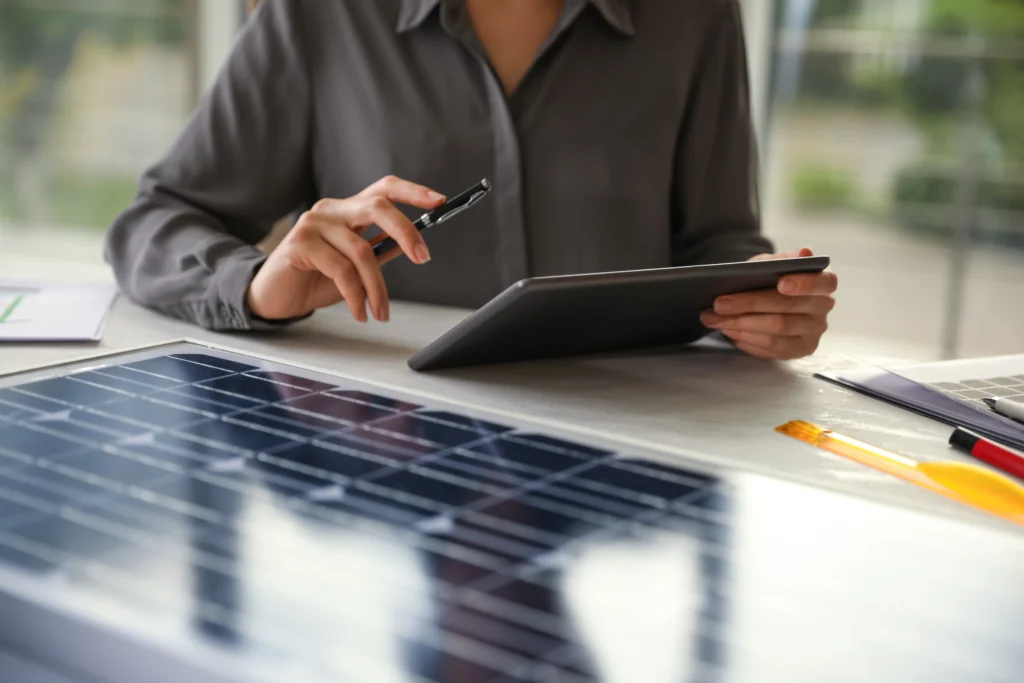 A woman is holding a tablet and looking at the company’s environmental records, which are stored in the digital waste management tool